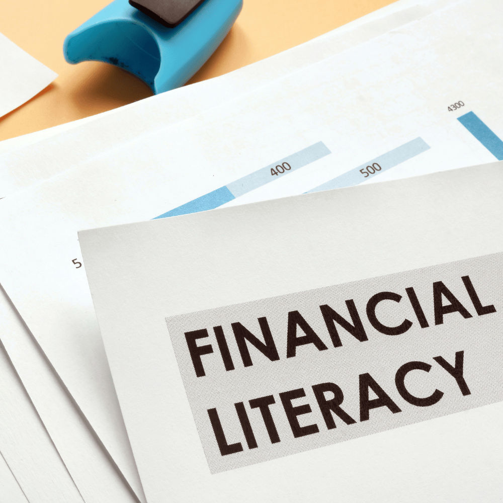 Financial Literacy bold on a stack of papers