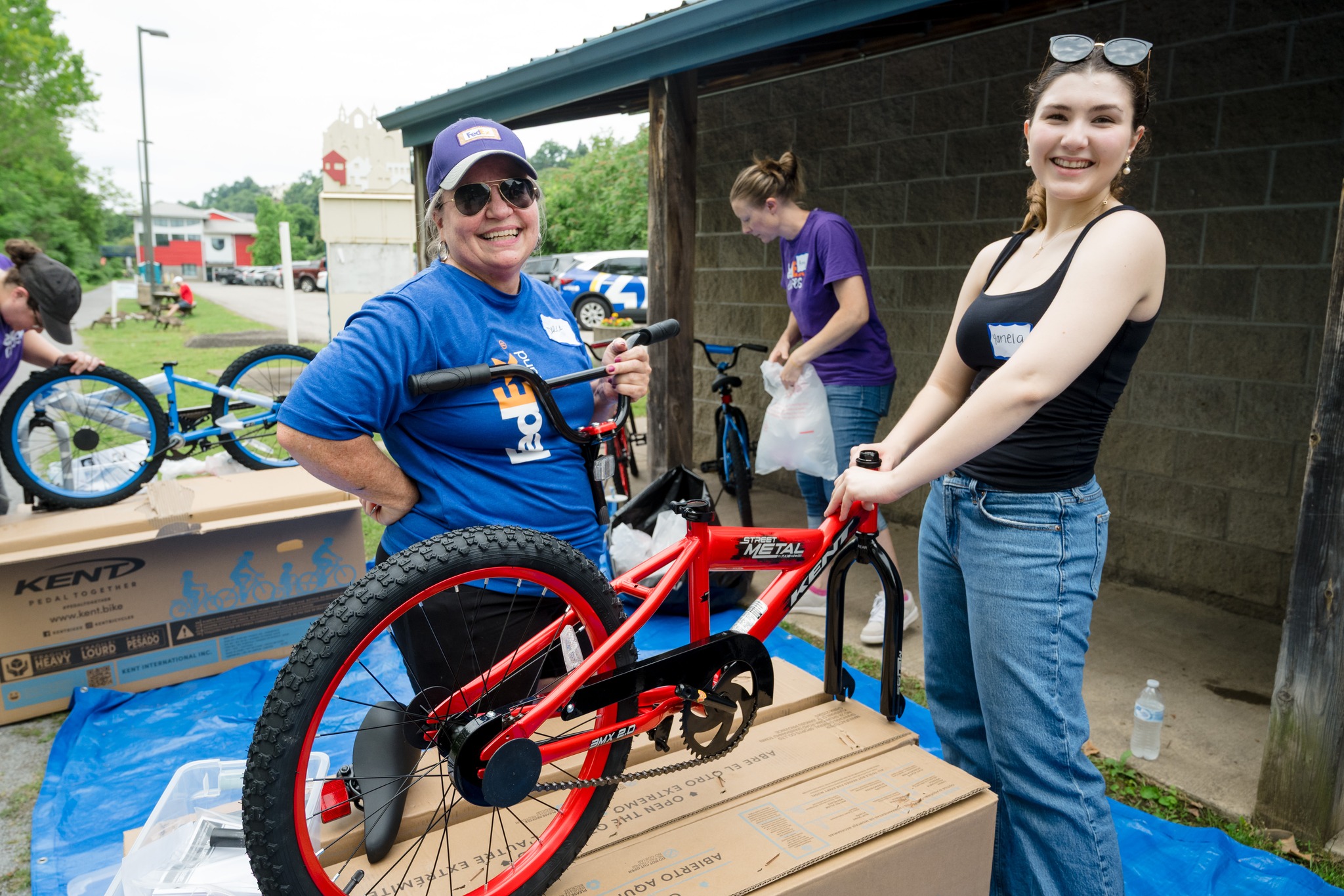 women assembling a red bicycle.